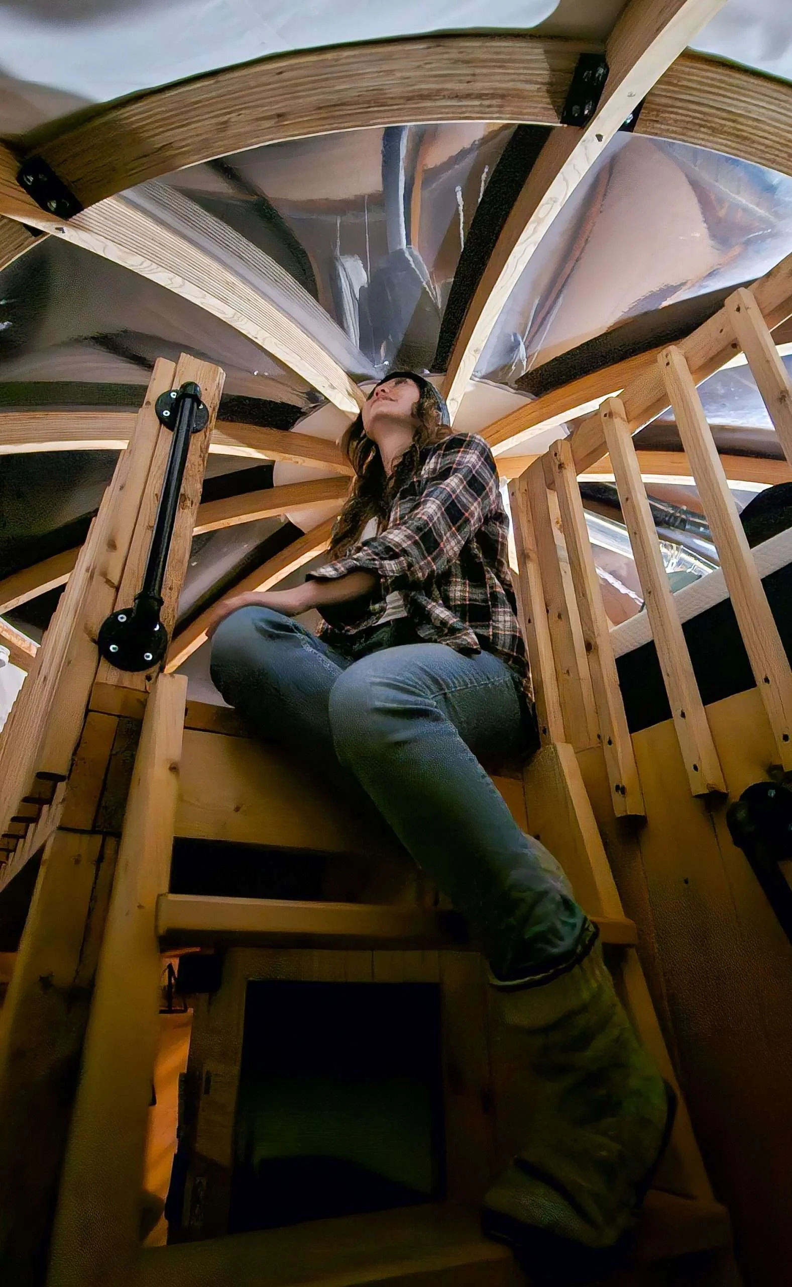 women looking at the stary sky through a dome window in a kamook at Imago Village in Saguenay Quebec